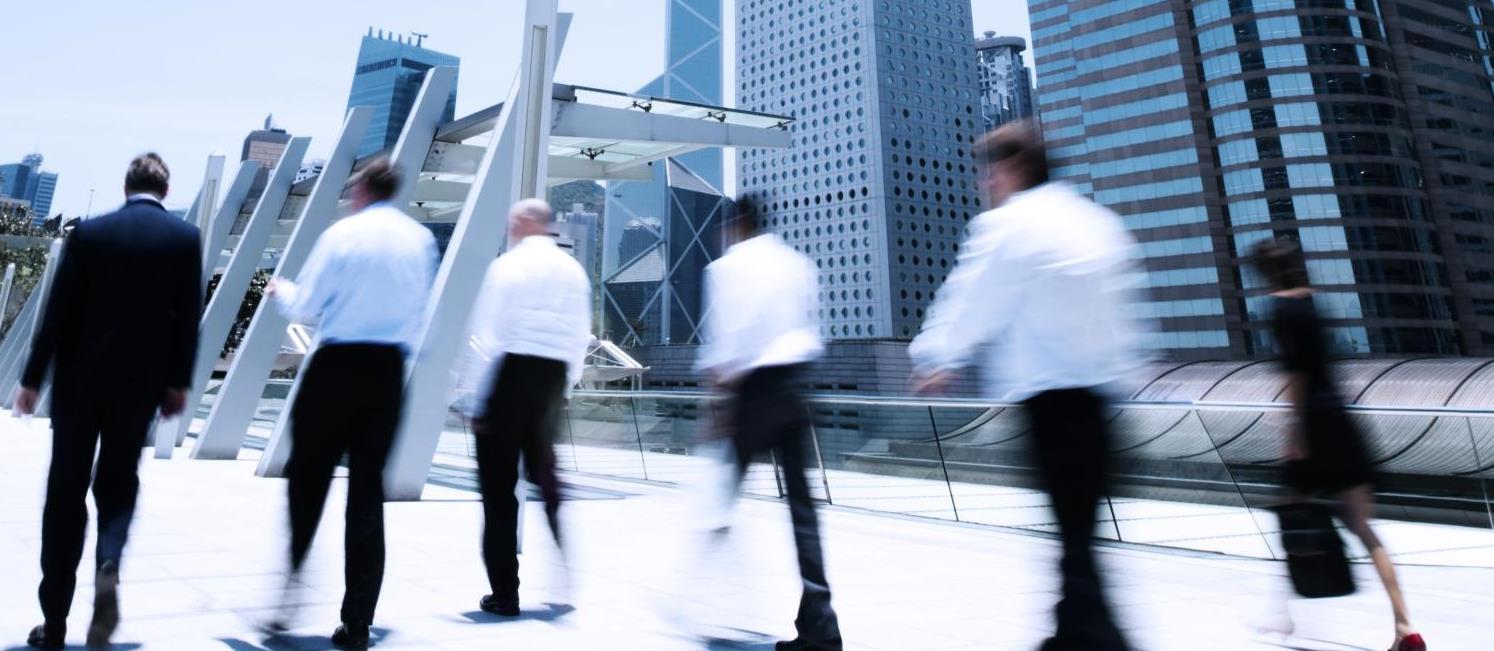 Business people walking across path in Hong Kong