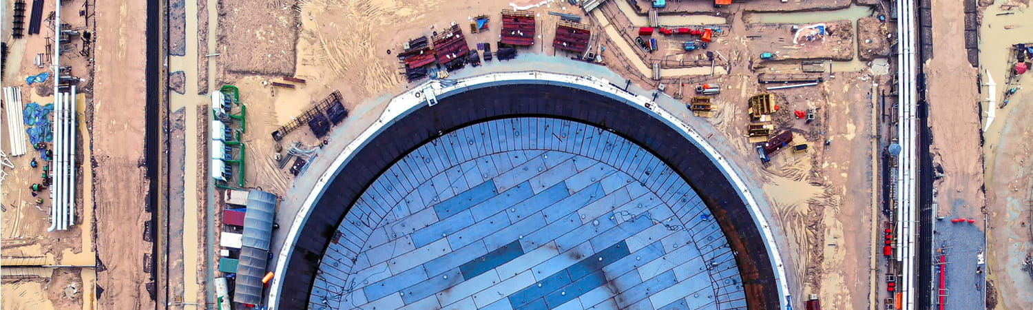 Aerial view of an oil tank construction site with vehicles and machinery